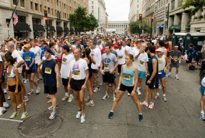 Runners begin warming up at the starting line minutes before the start of the National Press Club 5k.